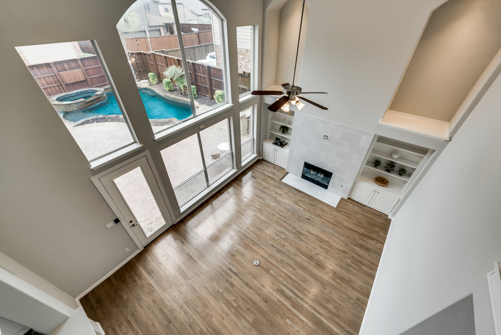    Family Room with    foot Ceilings and Wall of Paneless Windows 