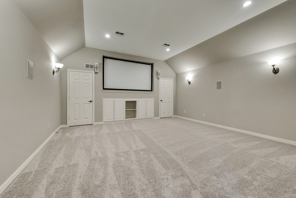    Media Room with Recently Installed Carpet Sconce Lights and Surround Sound 