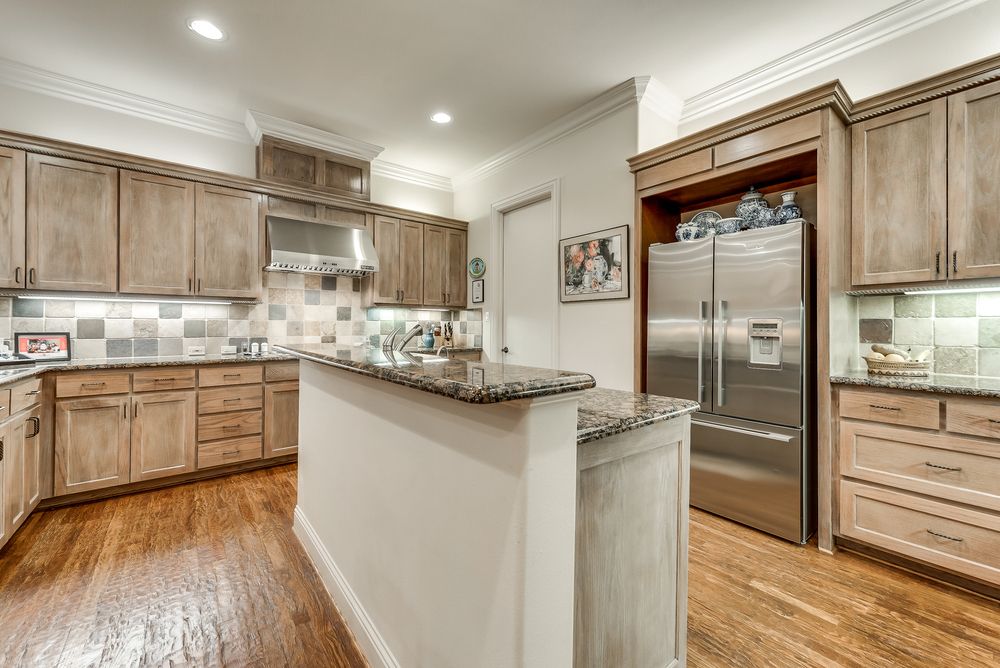    Gourmet Kitchen with Granite Countertops Stainless Steel Appliances and Breakfast Bar Seating 