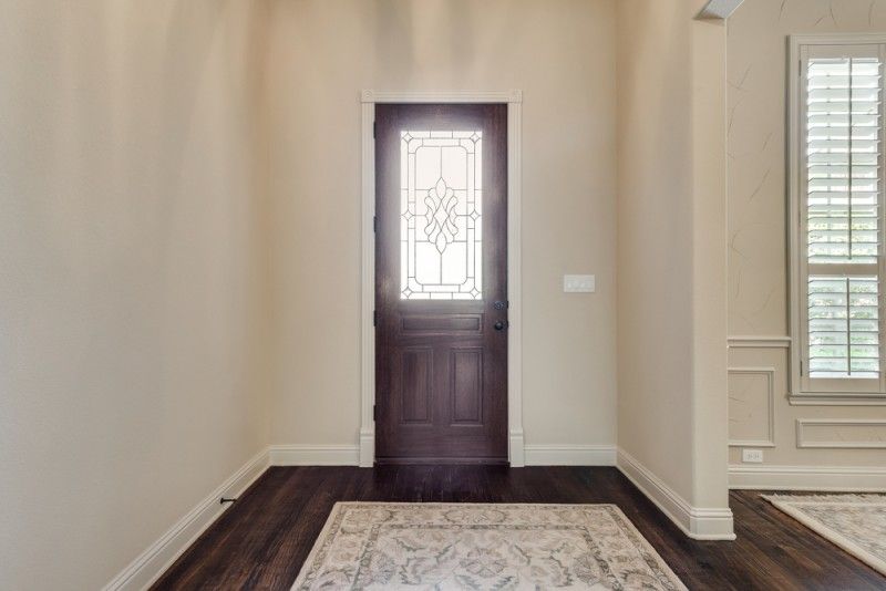    Glass Inlaid Front Door and Soaring Ceilings Welcome you Home 