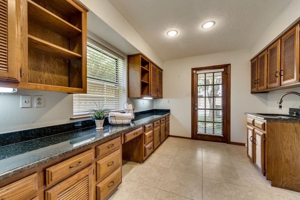    Spacious Utility Room has Room for Full Size Washer and Dryer Sink and Granite Top Workspace 