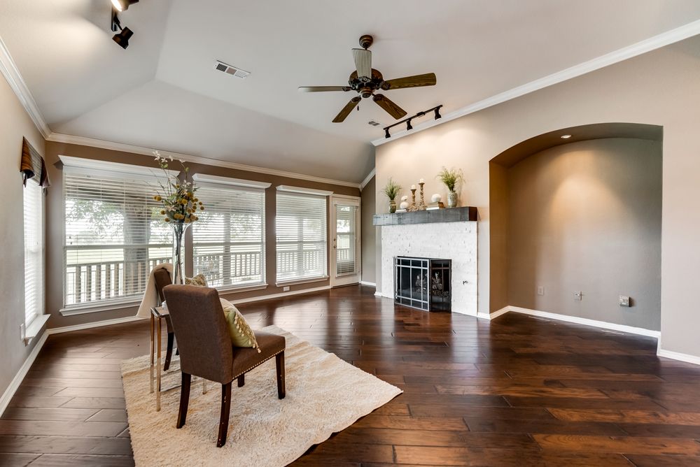    Family room with hardwood floors updated gas log fireplace and wall of windows with golf course views 