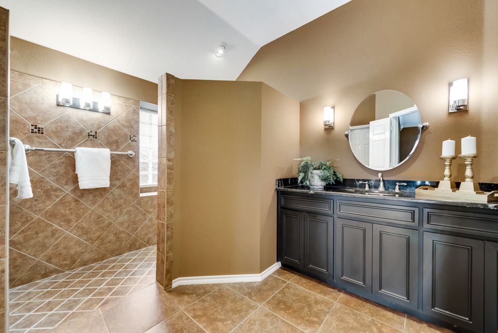    Master Bath offers separate vanities and granite countertops 