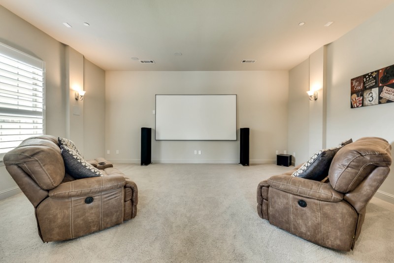    Media Room with Sconce Lighting and Large Closet 