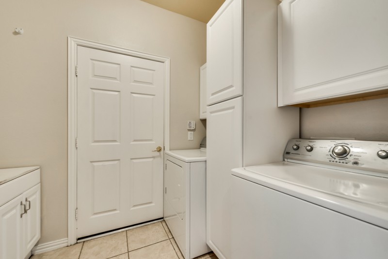   Utility Room with Custom Built In Cabinetry and Room for Fridge 