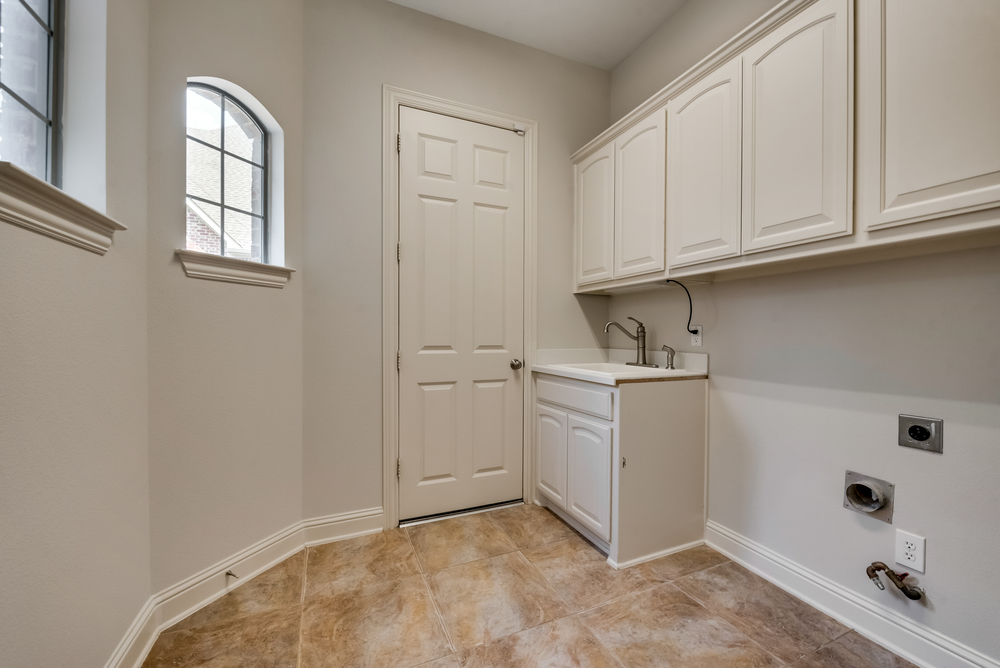    Laundry Room with Built in Cabinetry and Sink 