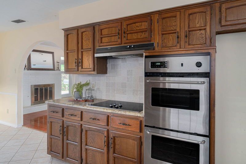    Kitchen with double ovens and glass cooktop 