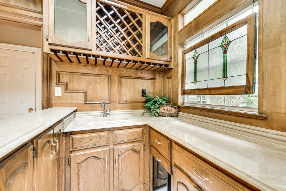    Wet Bar Offers Built In Cabinetry Sink and Wine Cooler 