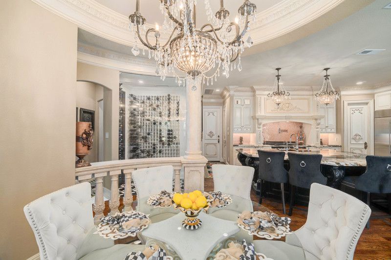    Breakfast nook with cast stone columns and stunning chandelier 