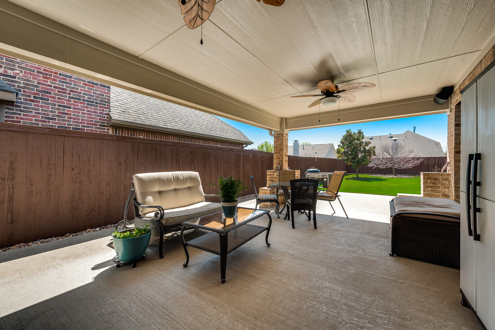    Cozy Covered Back Patio with Ceiling Fans and Speakers 
