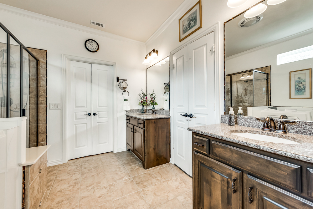    Spa Like Master Bathroom features Separate Vanities with Granite Countertops 
